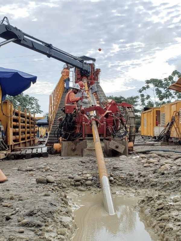 Horizontal directional drilling rig executing a crossing beneath a watercourse