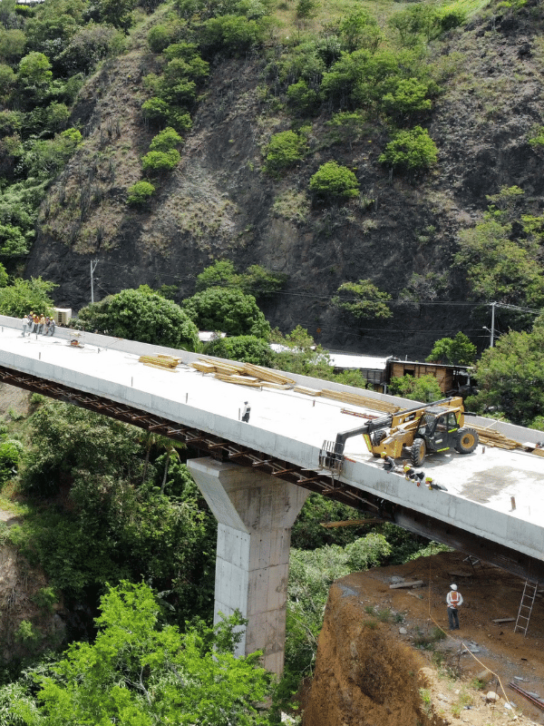 Viaduct under construction over mountainous terrain